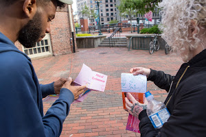 Two individuals looking at pamphlets in Market Square