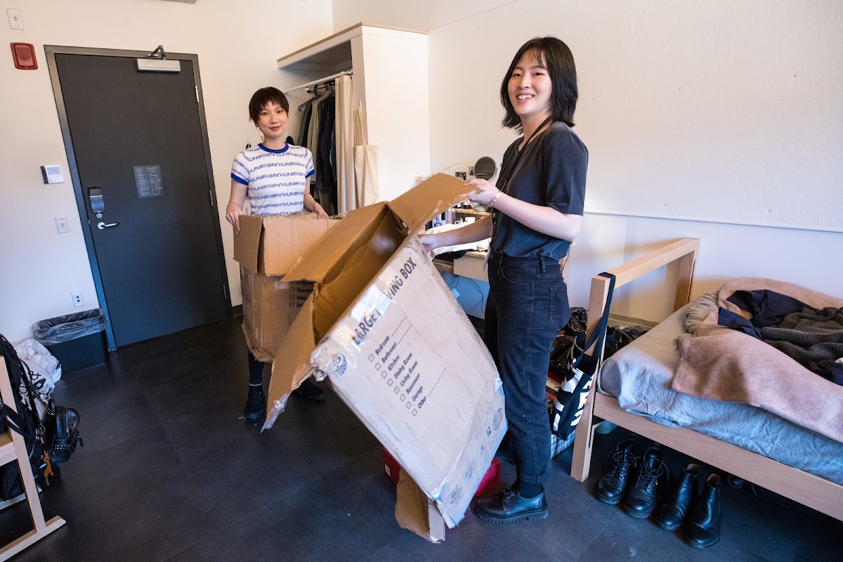 Students unpacking in a North Hall dorm room