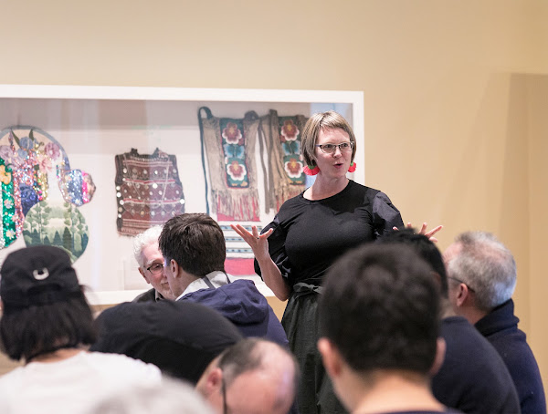 Curator of Costume and Textiles Kate Irvin welcomes faculty to the Upper Farago Gallery in the RISD Museum