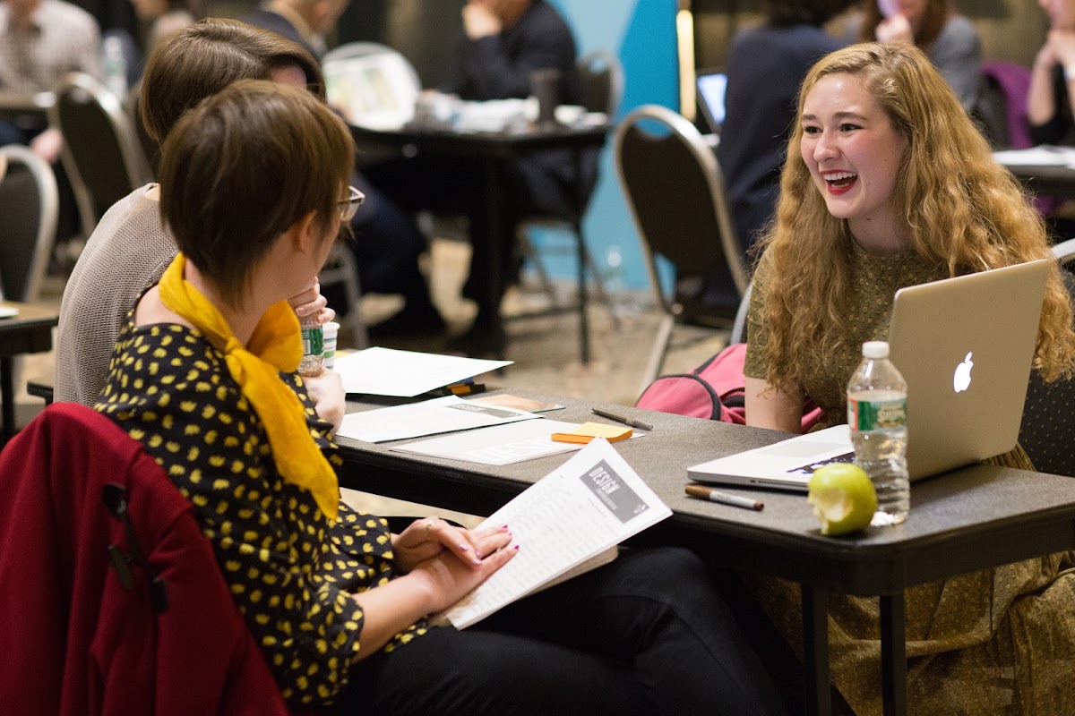 Student in conversation with professionals at the Design Portfolio Review
