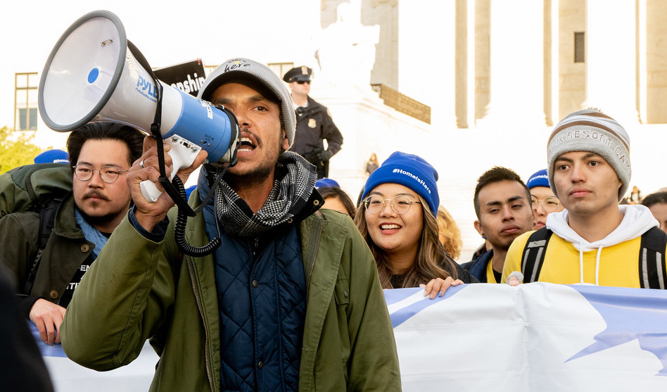 Man in a protest speaking through a speakerphone