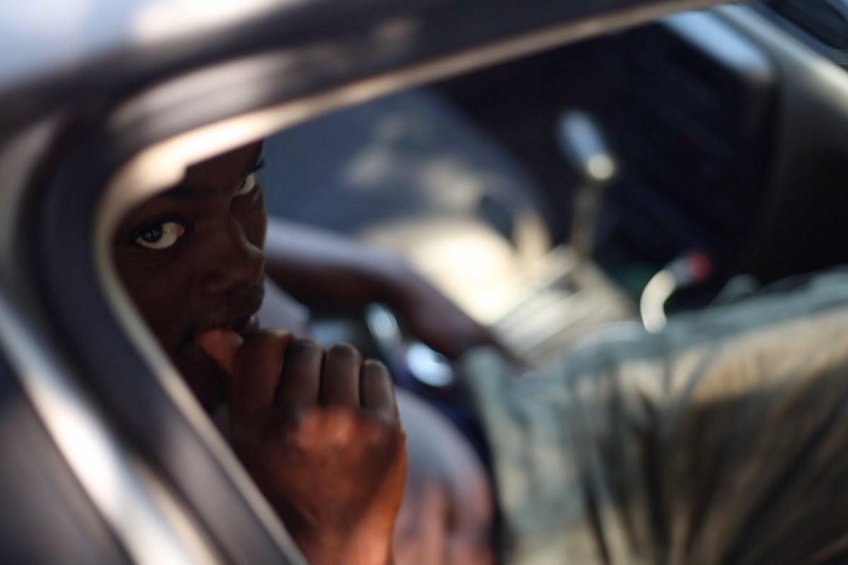 Person looking out of open car window