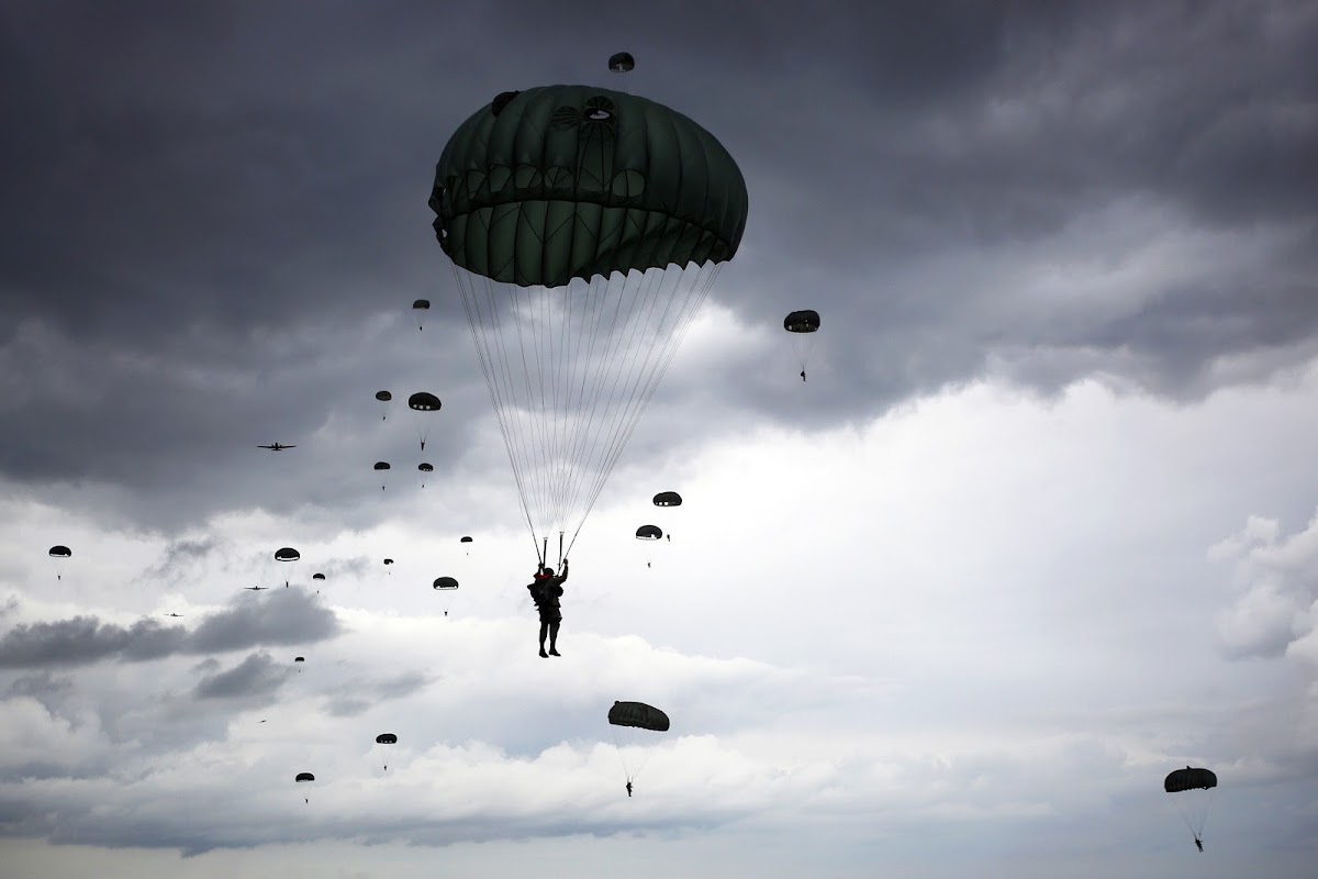 Photo of many people parachuting by Luke Sharrett, for NPR