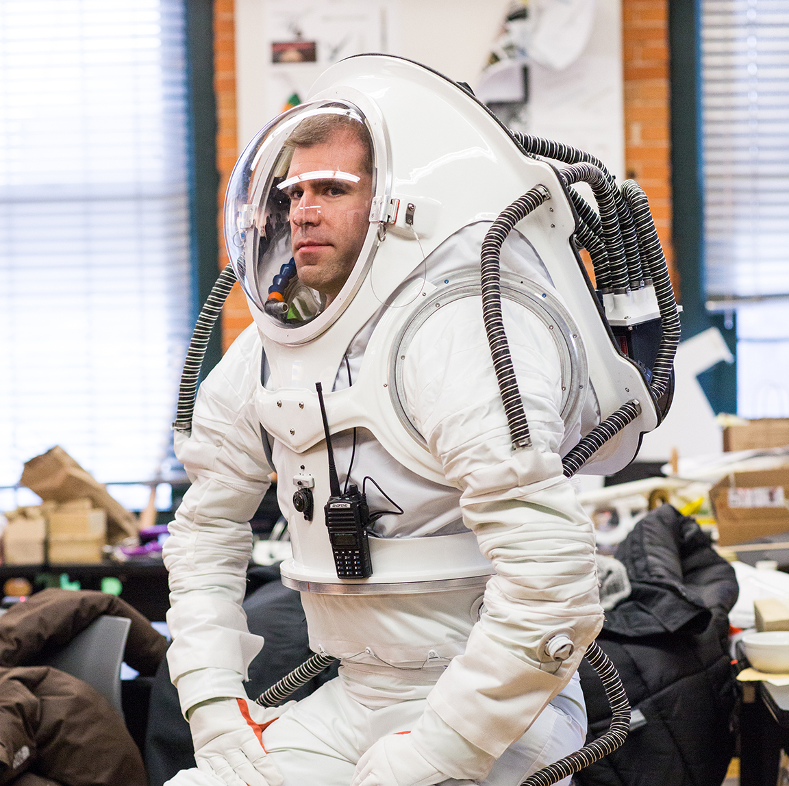 HI-SEAS crew member Andrzej Stewart wearing a modular space suit designed by students Erica Kim 18 AP/ID and Kasia Matlak MID 17