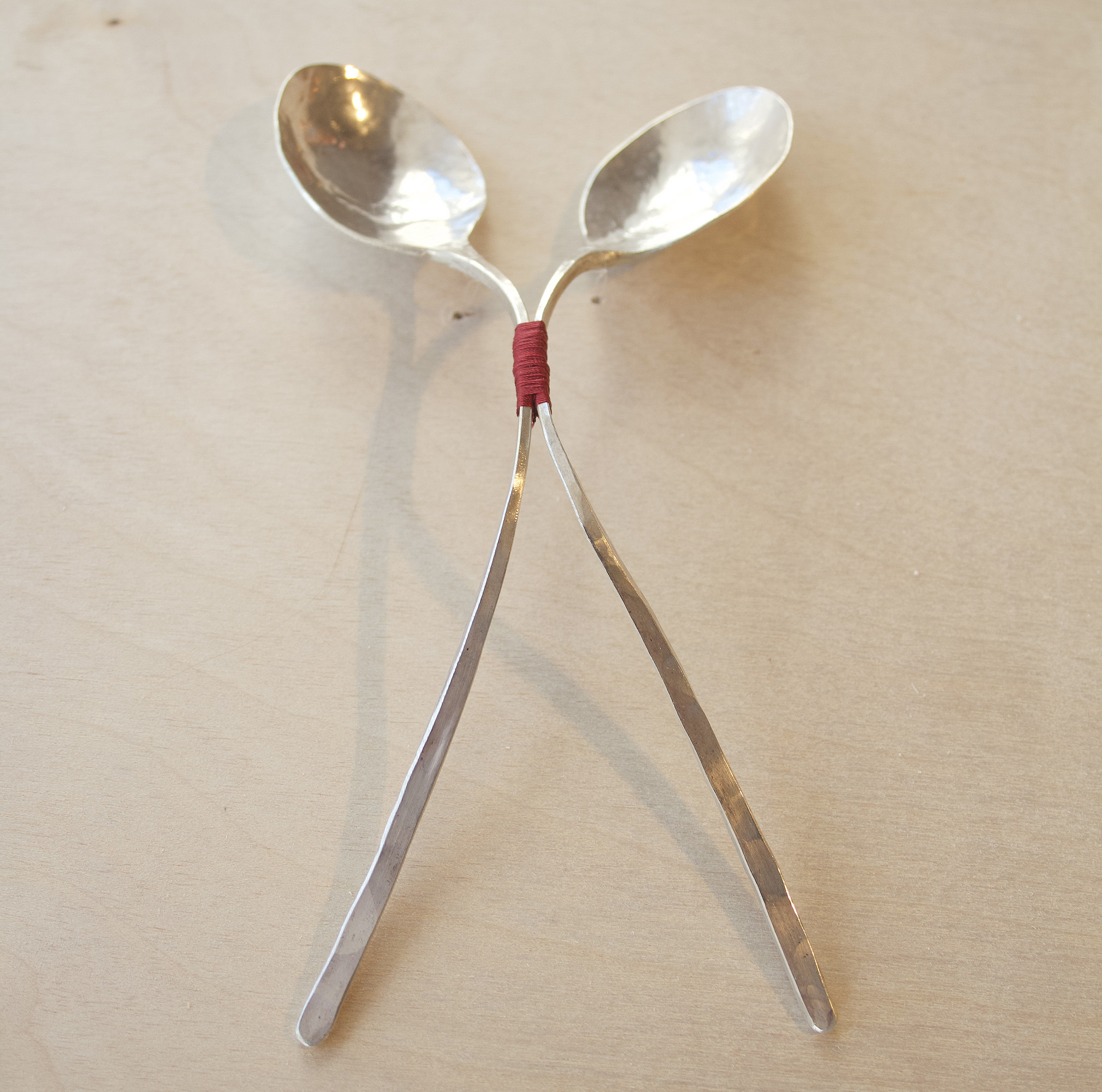 a pair of spoons connected
