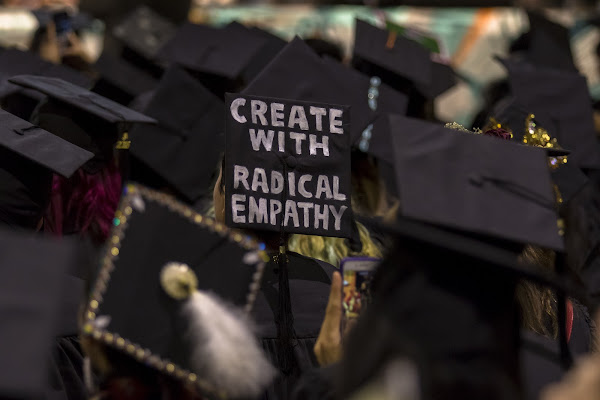 Graduation cap with words "create with radical empathy" painted on it