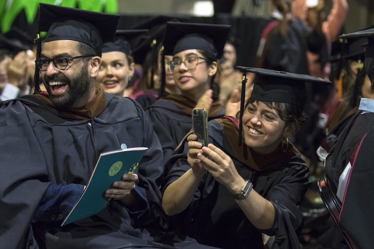 Happy students, in their caps and gowns, during their graduation ceremony