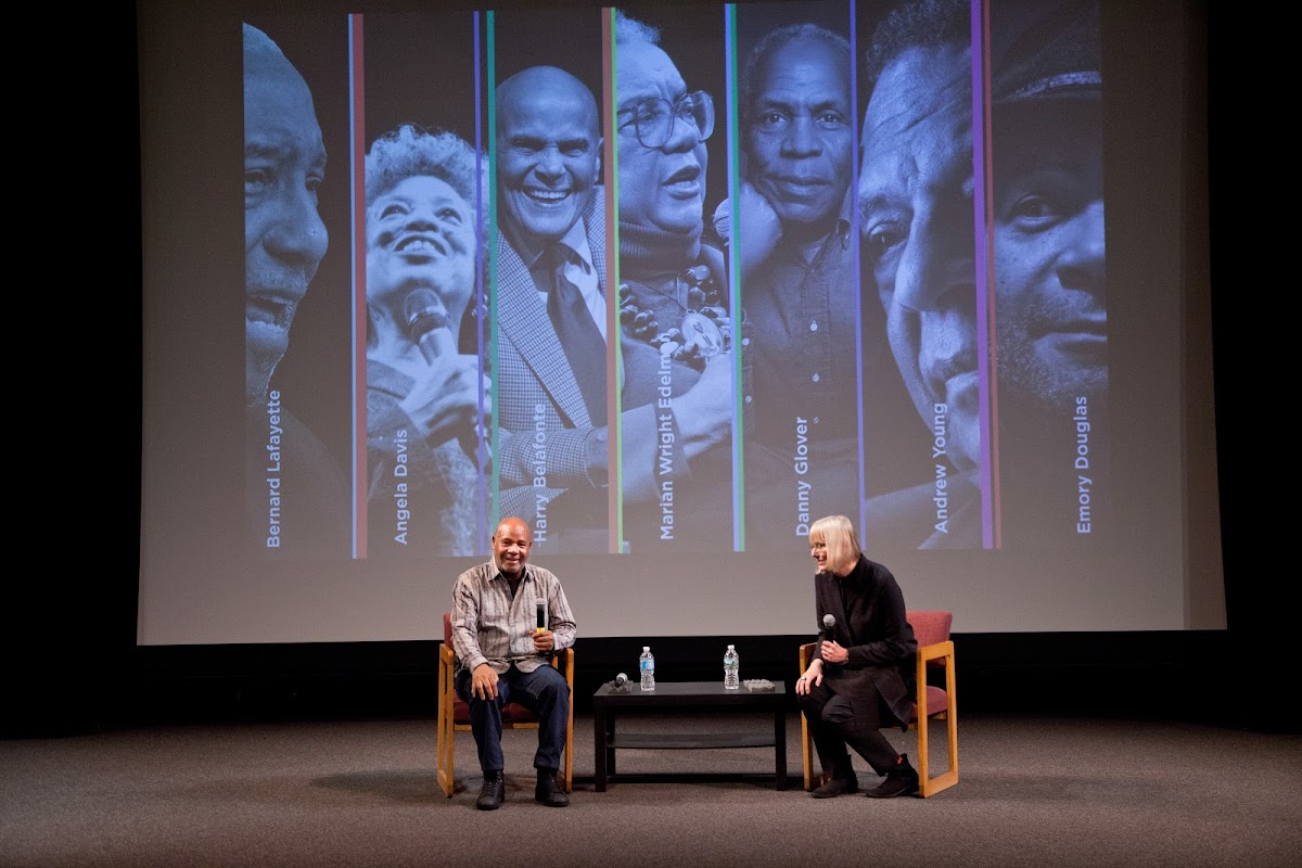 Artist, activist and Black Panther Party member Emory Douglas on stage with Graphic Design Professor Nancy Skolos