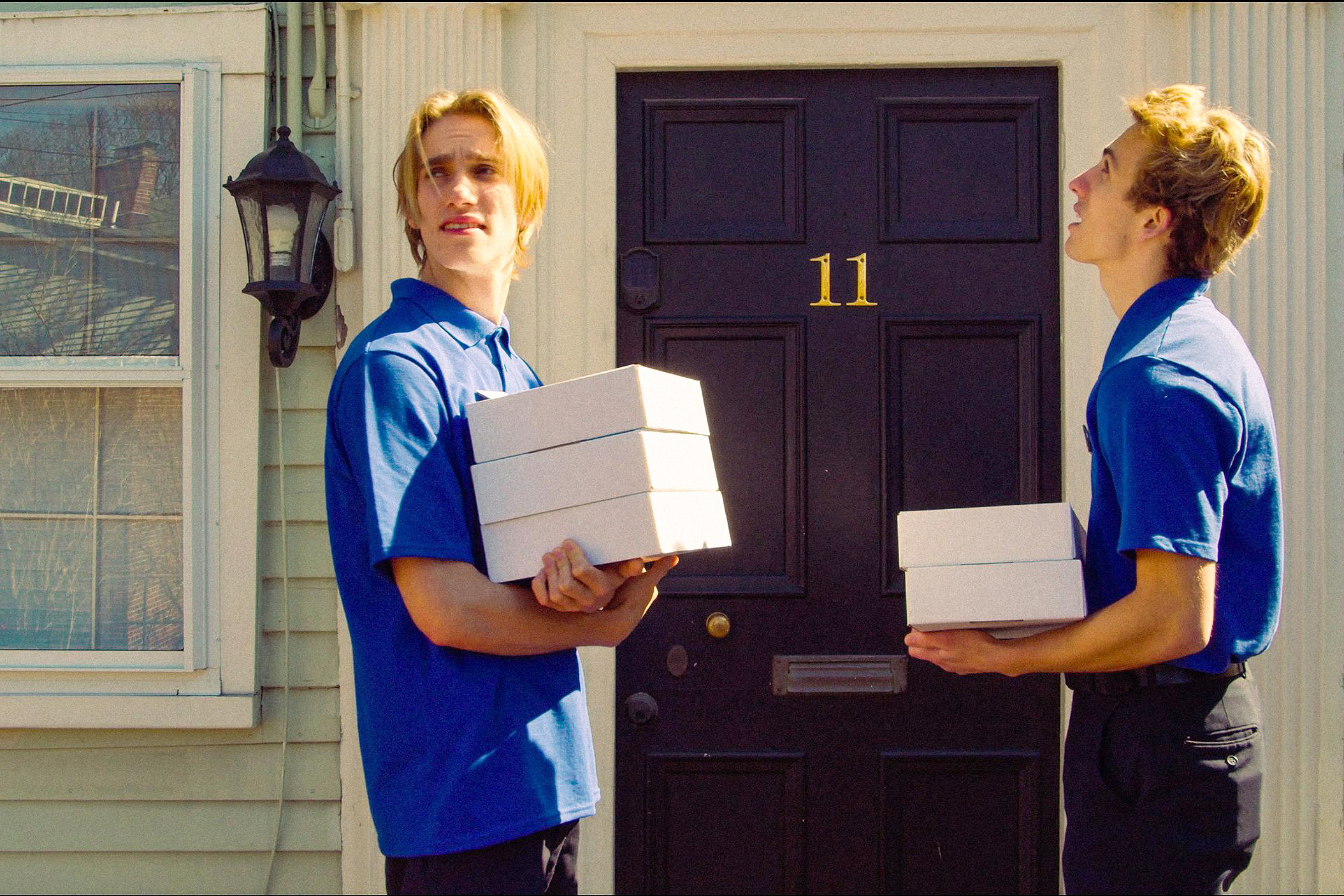 two young salesmen at the door of a potential client
