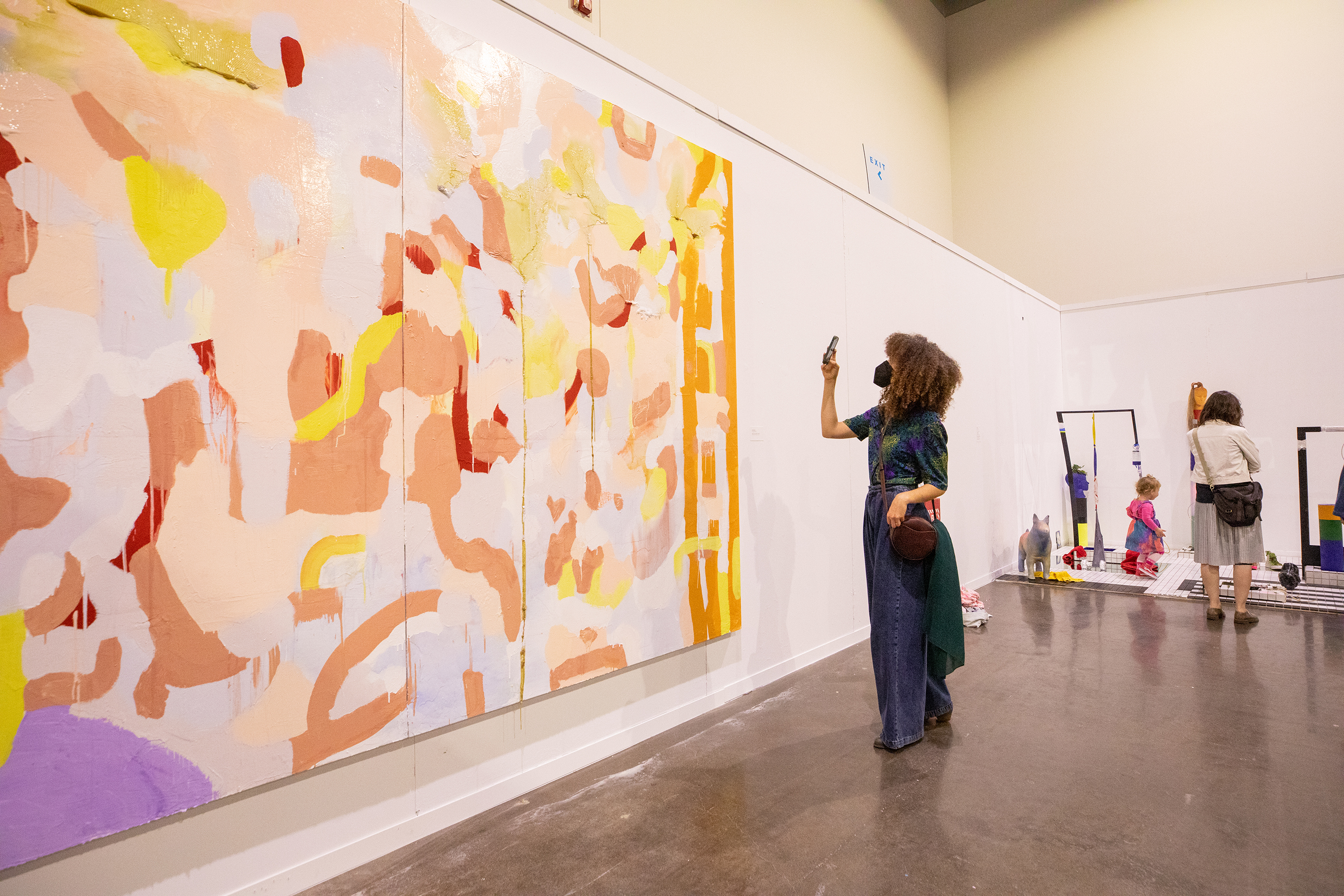 a visitor photographs a huge abstract painting