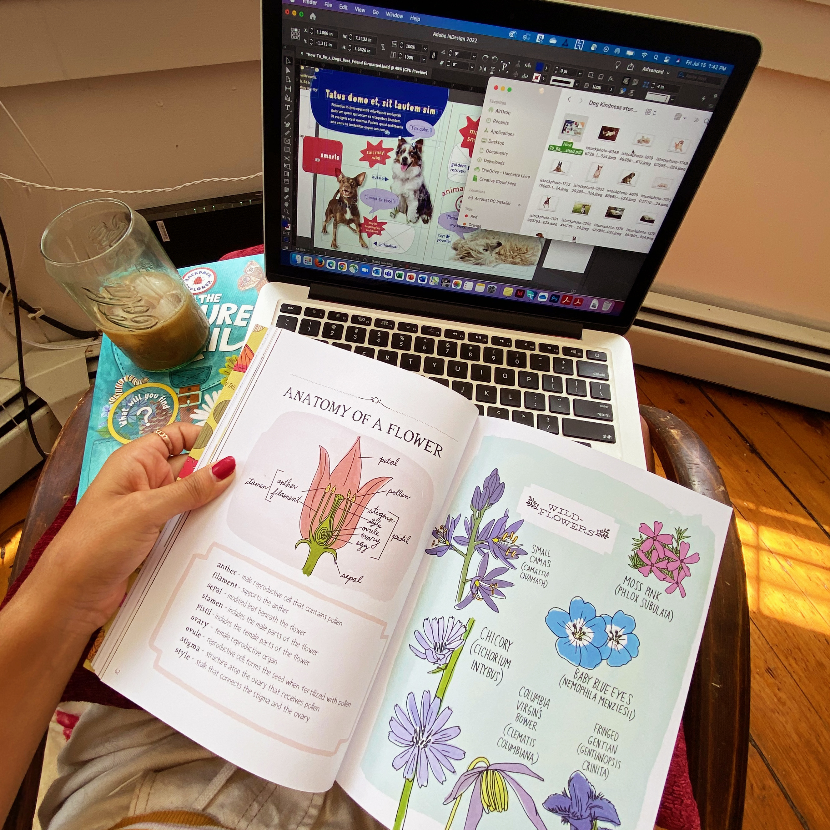 A photo of Graciela Batista 24 IL's work from home setup: a laptop, iced coffee, and illustration book