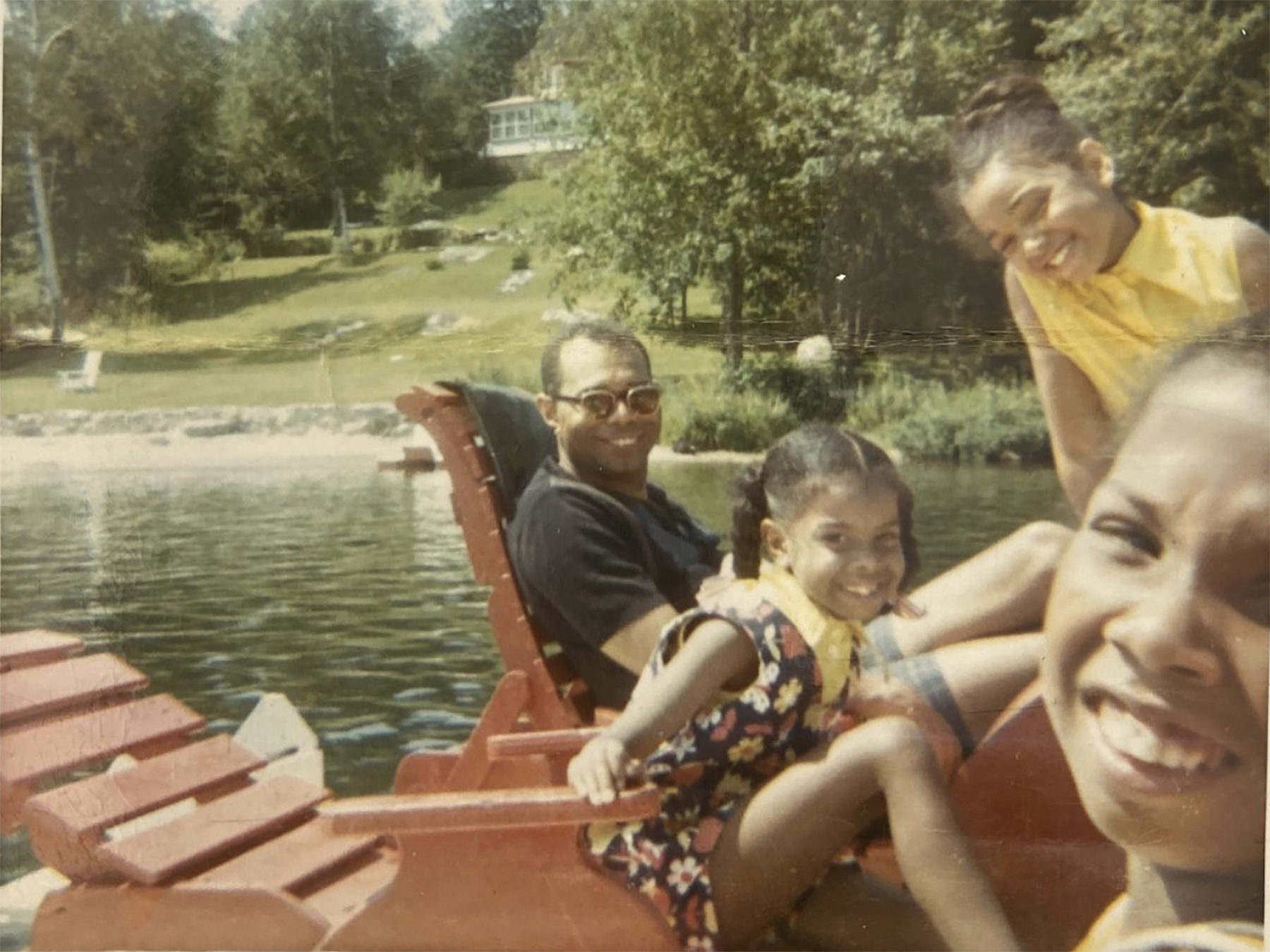 a Black family relaxing lakeside