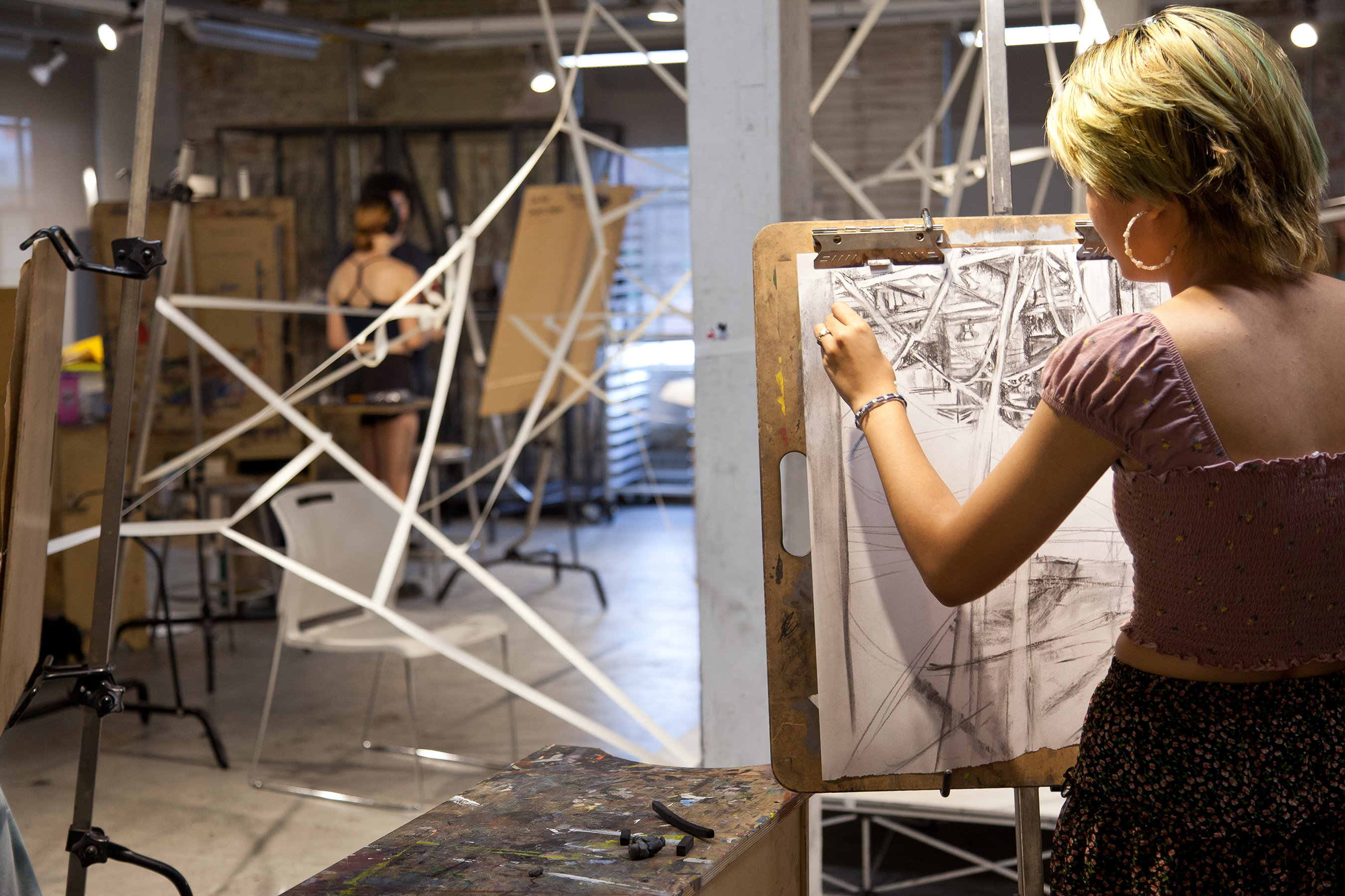 student drawing at an easel