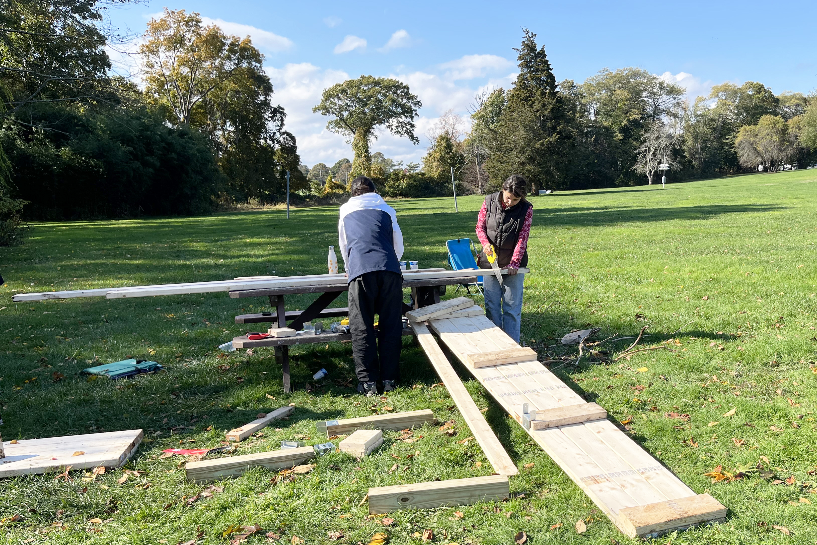 students screw pine boardwalks together