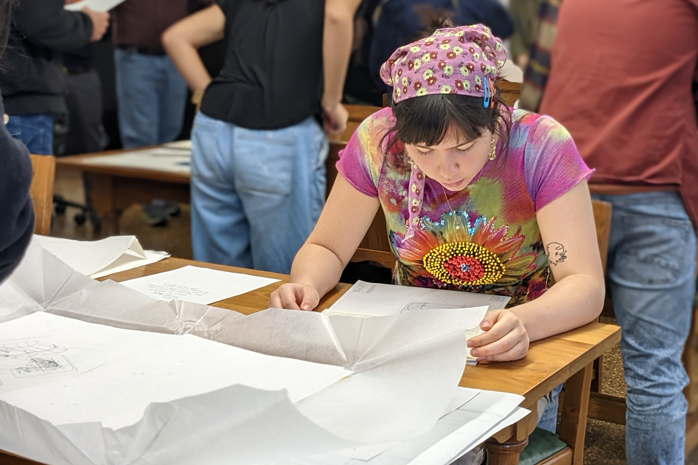 a student reviews an old design file in the archives