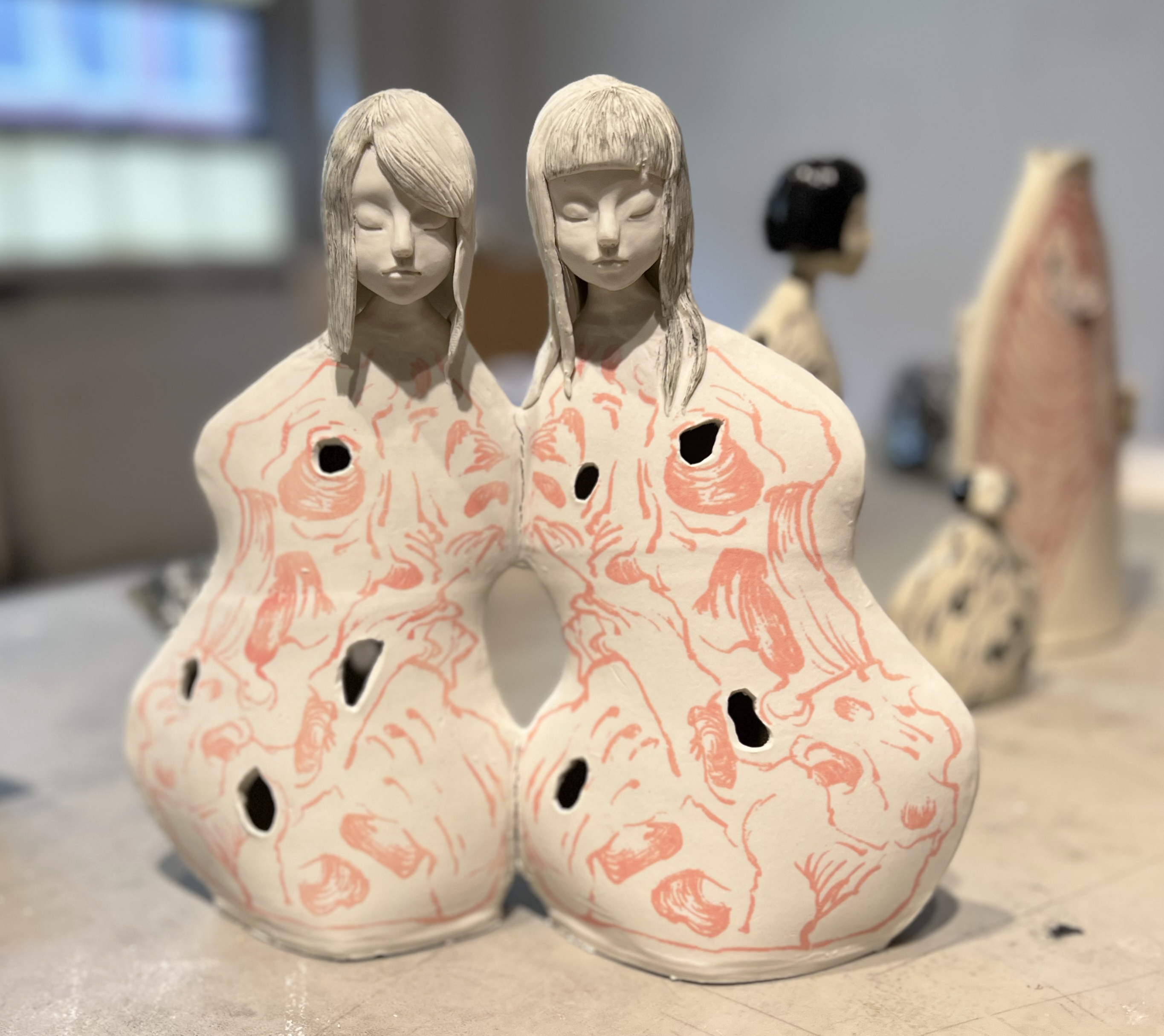 two-headed porcelain figure by Yilina Yang