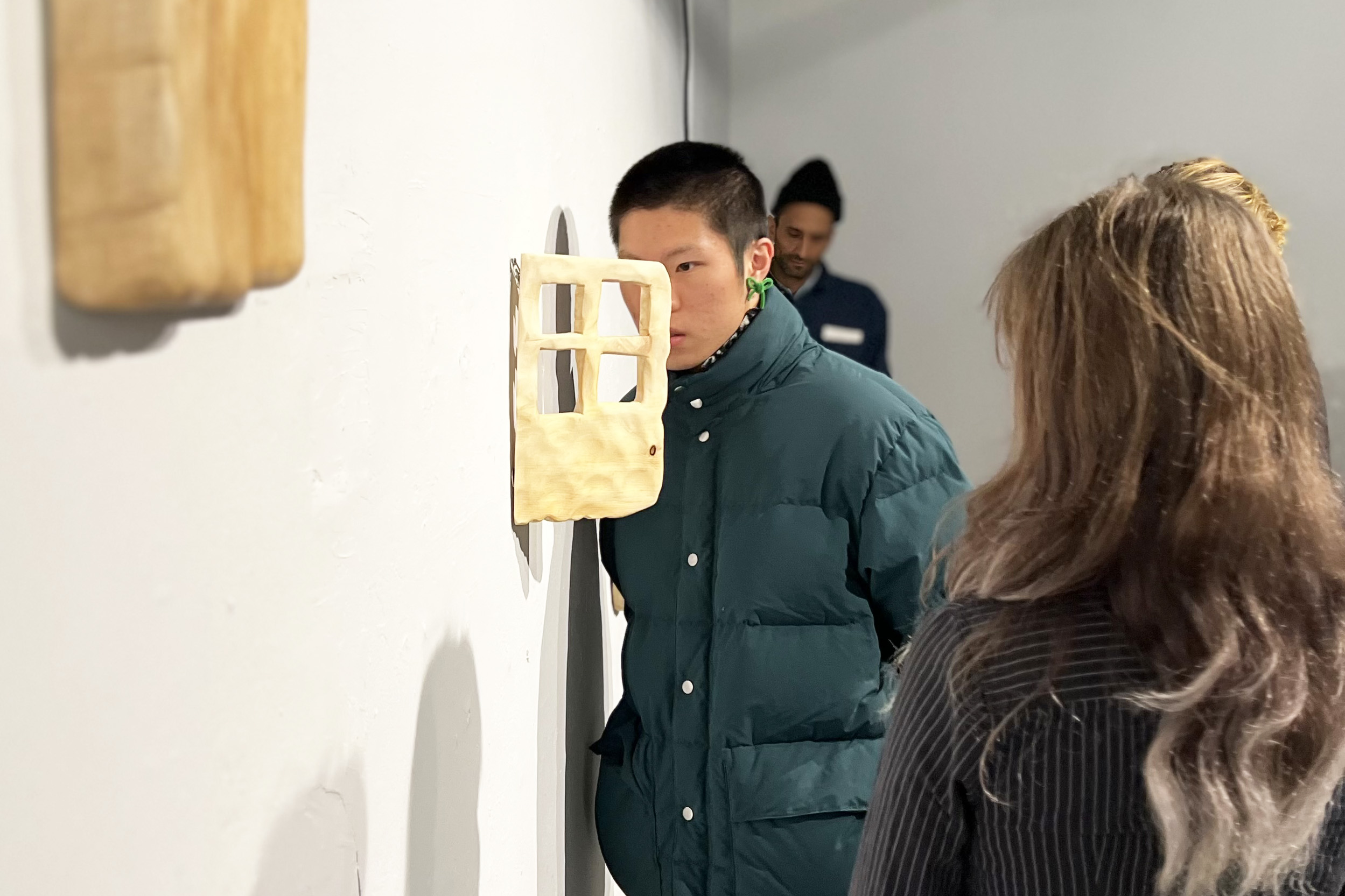 a student gets a close look at a wall-mounted piece