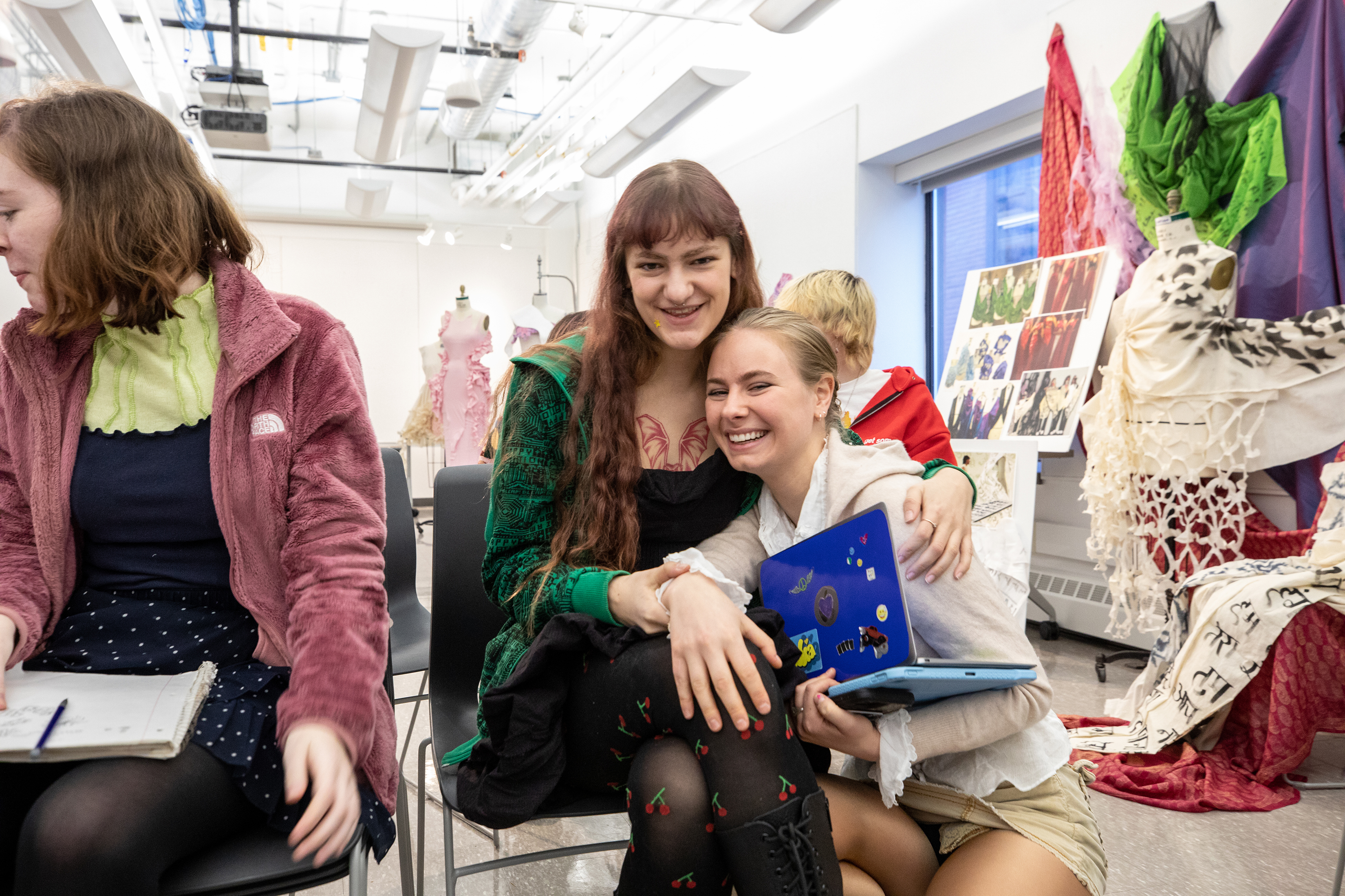 students hug during crit