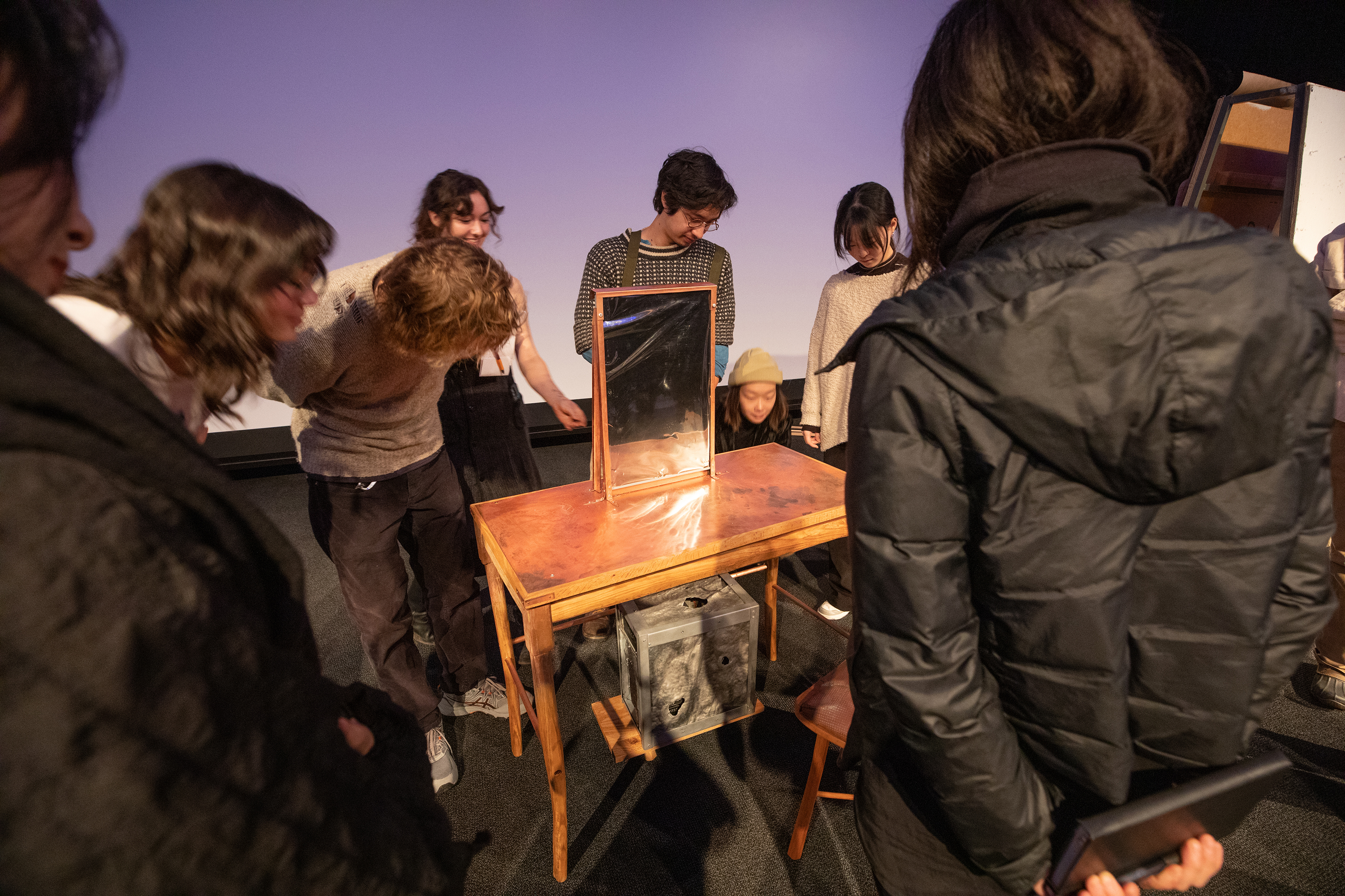 students examine furniture pieces by Sara Hollaway