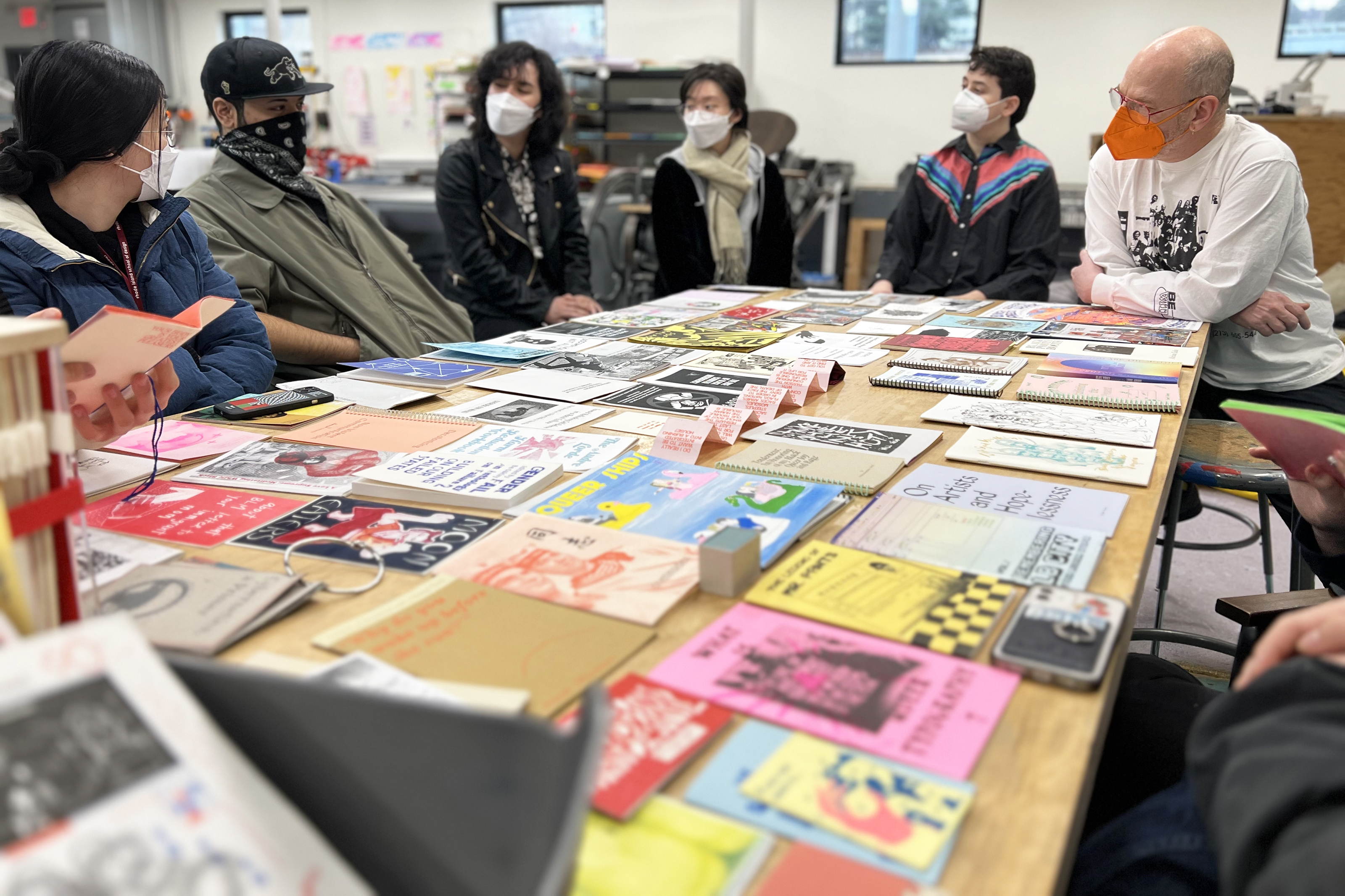 Students sit around a table at Queer.Archive.Works and discuss the history of discrimination against queer artists and artsits of color in archives with Graphic Design Department Head Paul Soulellis