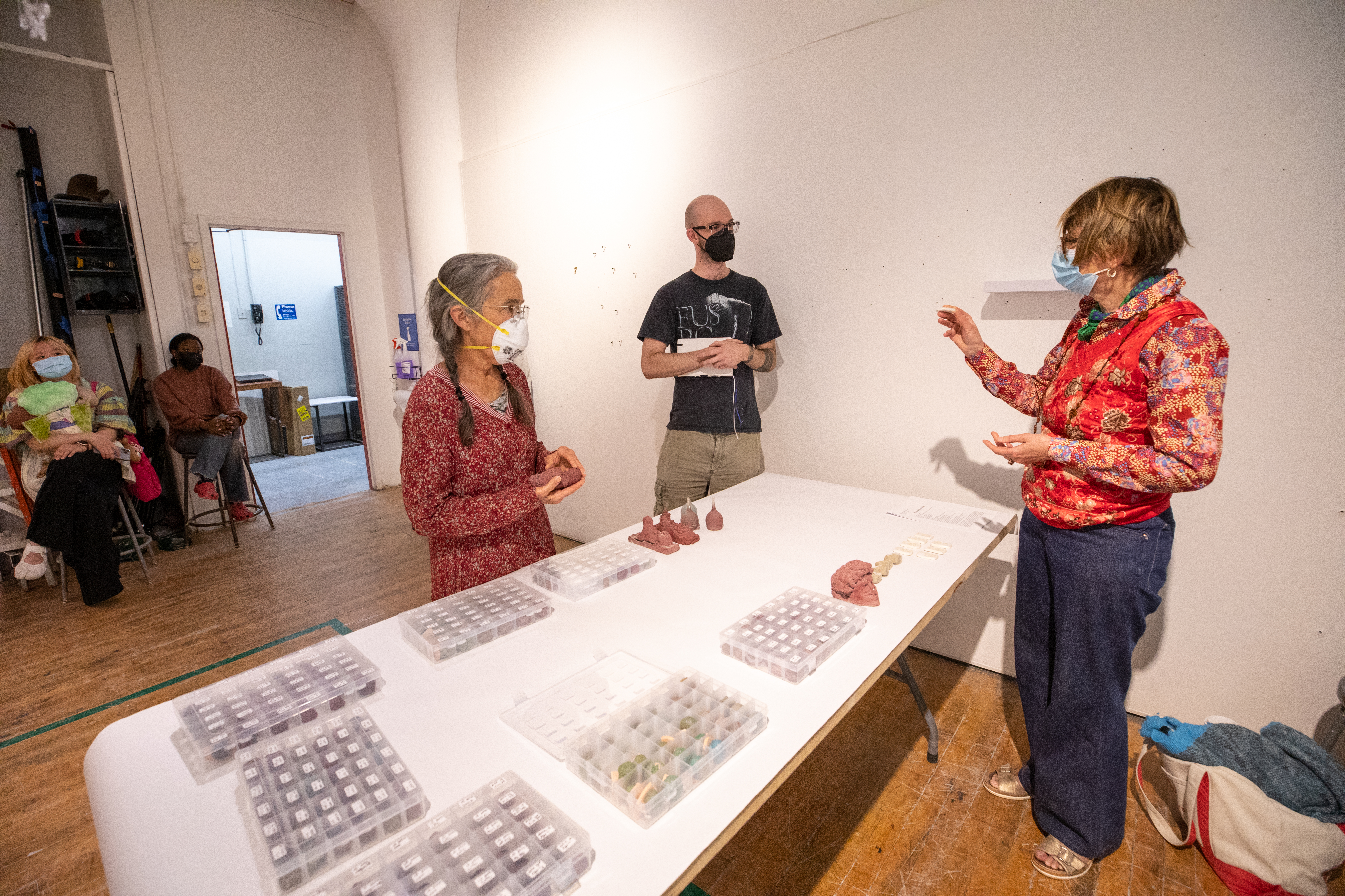 Ceramics Department Head Katy Schimert examines Sussman's work