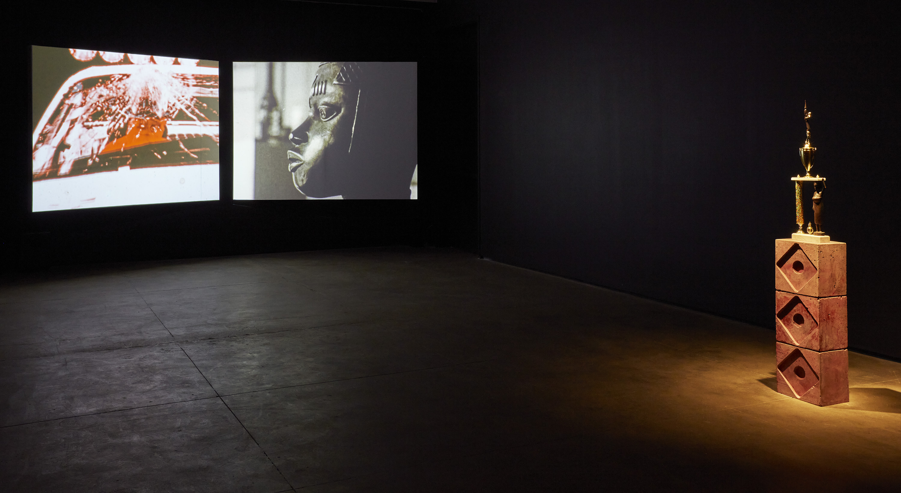 darkened gallery showing Okokon installation including video