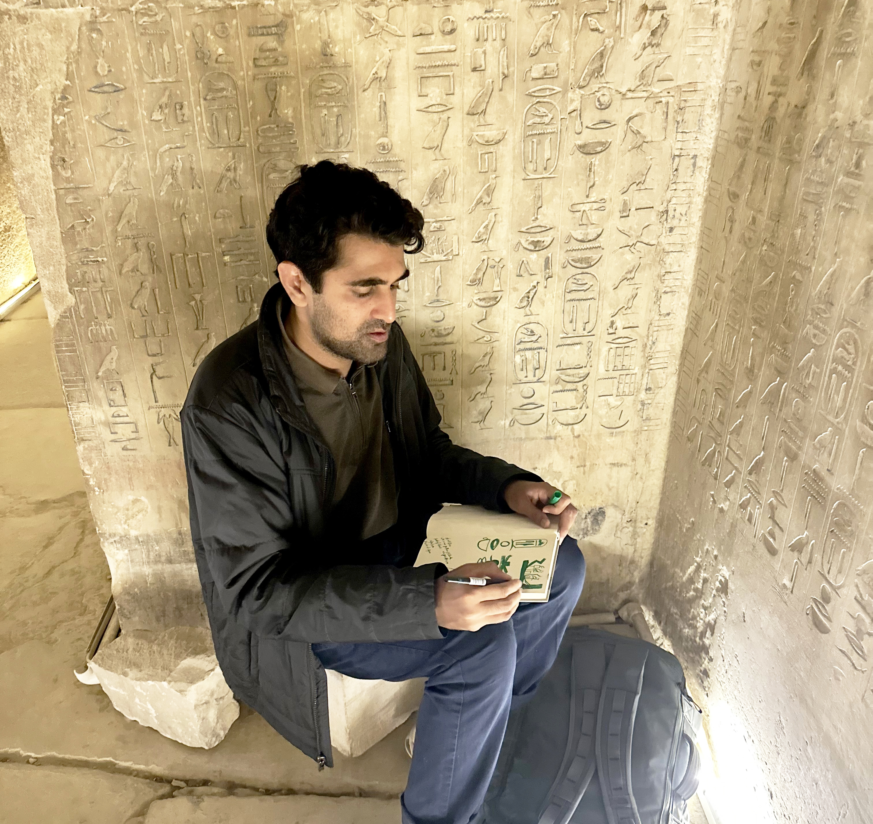 Mithani sketching inside an Egyptian tomb