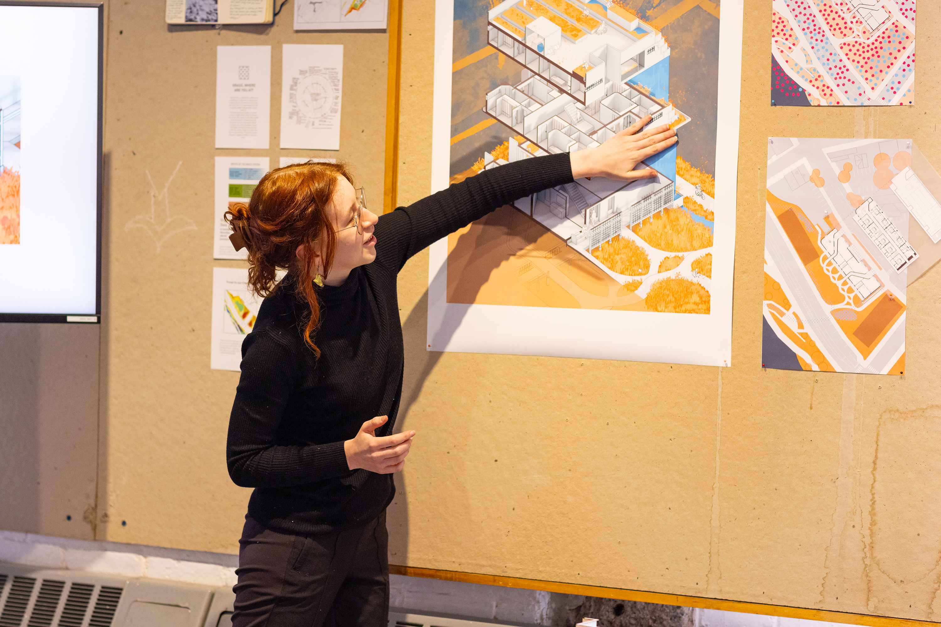 an architecture student presents renderings at spring crits 2025