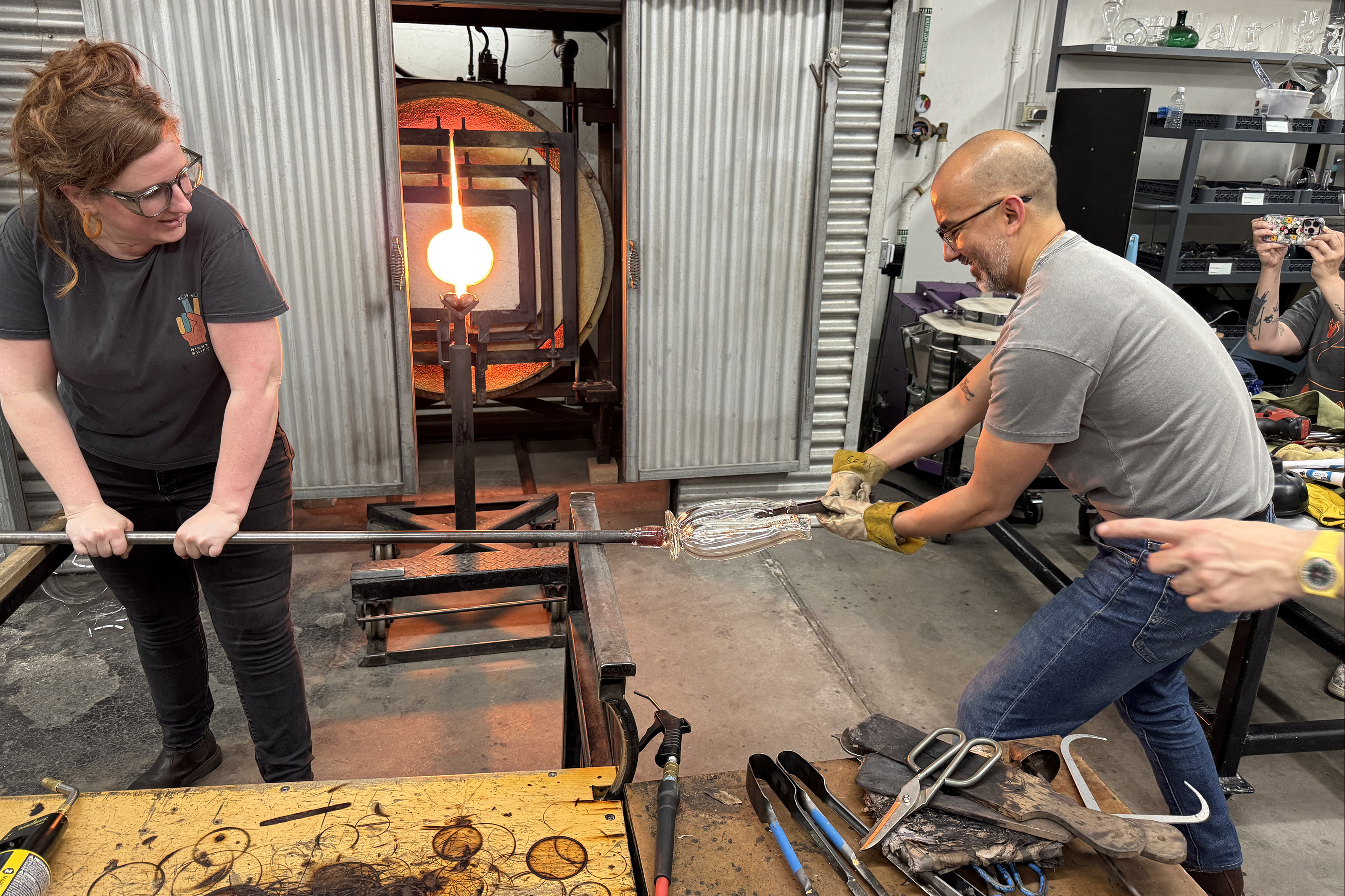 Valdez in the hot shop with faculty member Karin Forslund and glory hole in the background