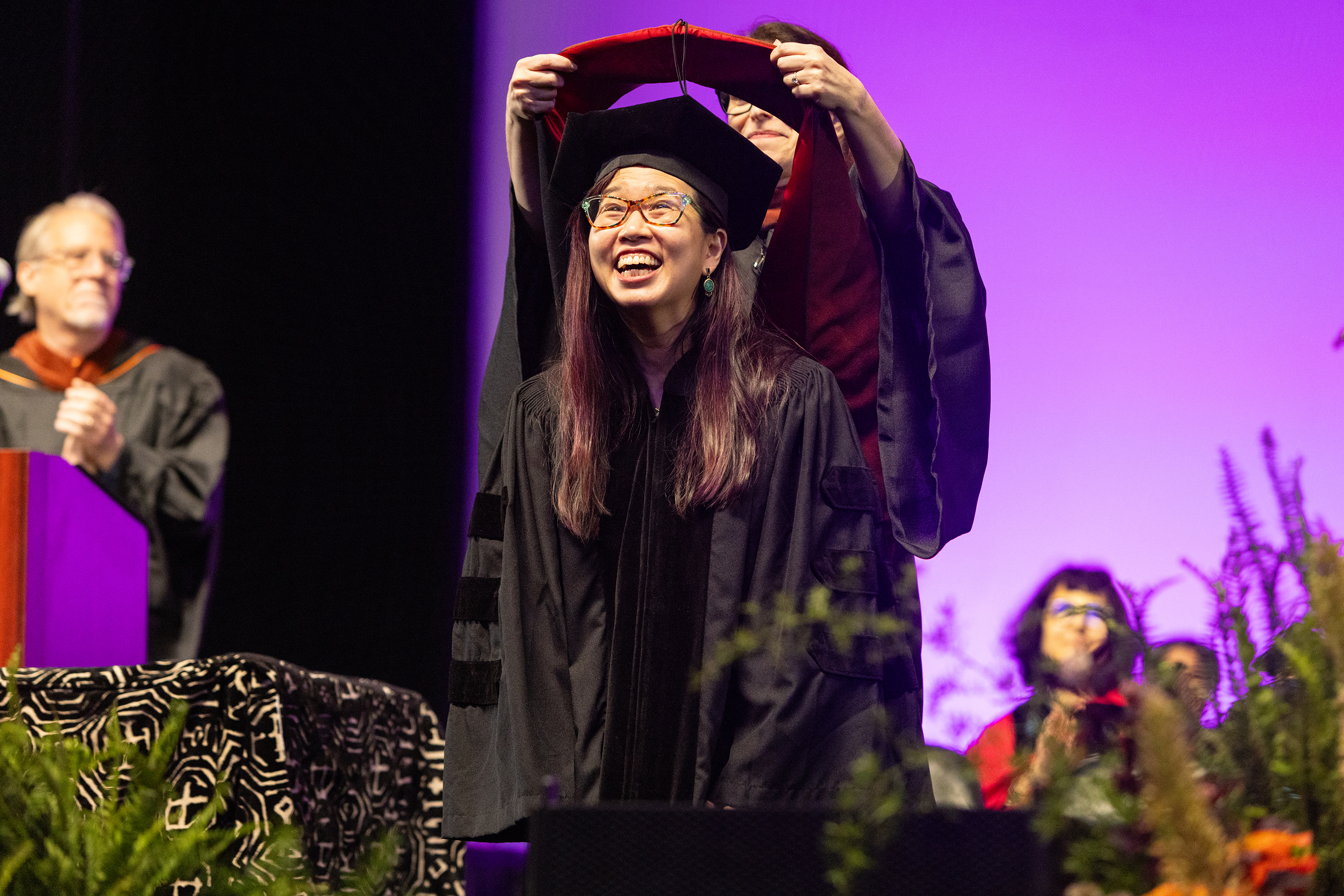 Honorary Degree recipient Grace Lin accepts her hood