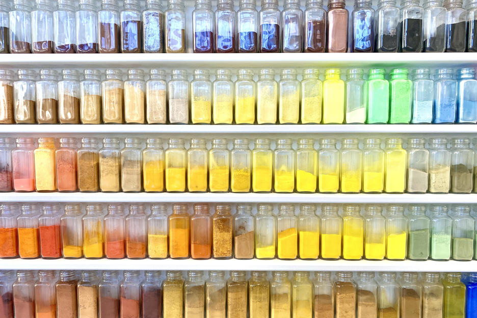 jars of different-colored pigments sit on shelves lining a wall of RISD’s Color Lab