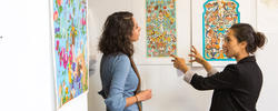 MacArthur-winning alum Shahzia Sikander and a RISD student discuss student work during a studio visit