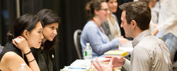 two reviews speak with a student about their work during a Design Portfolio Review