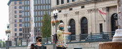 RISD professor giving direction to a student drawing outside