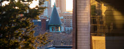 a view from the risd quad of greenery and the tip of carr haus