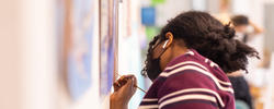 close up of student painting against a studio wall