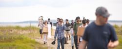 RISD Students walking along a wetlands area coming up from the bay