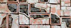 detail of assembled blocks of repurposed stones and red brick