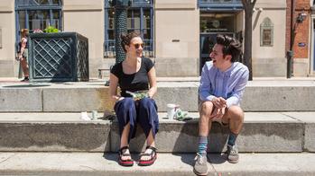 Students sitting and talking on River Walk steps