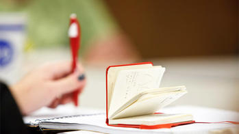 Student at table with open notebook