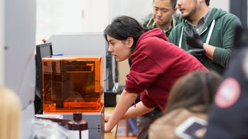 Student working with a 3D printer