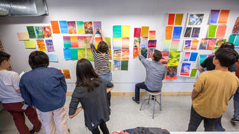 a wide-angle view of students at an Illustration crit