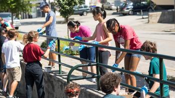 Student volunteers clean up Billy Taylor park on the East Side of Providence