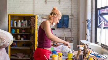 Student mixing materials in sculpture studio.