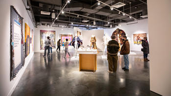 people gather in a spacious gallery for The Black Biennial