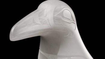 glass sculpture of a raven's head