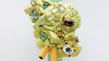 close-up of an intricate yellow ceramics bauble