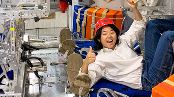 Student in a NASA capsule during their internship