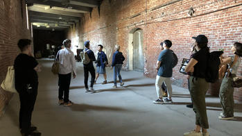students gathered in a brick hallway