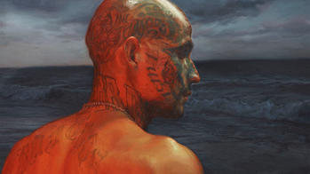 tattooed skin-headed young man from the back